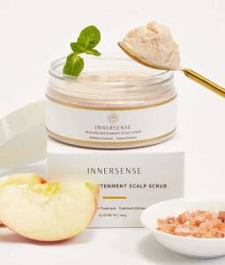 En æske Innersense True Enlightenment Scalp Scrub 190g med et æble og en ske.