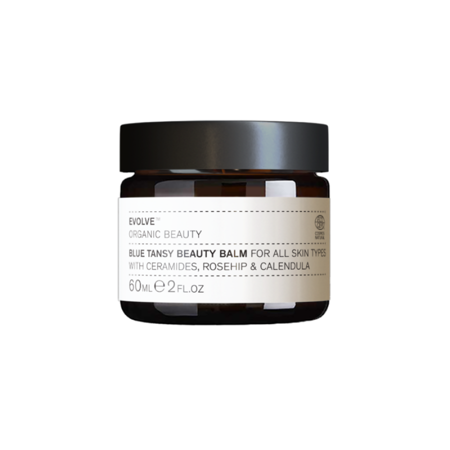 En krukke med Evolve Organic Beauty - Blue Tansy Beauty Balm 60 ml med sort baggrund.