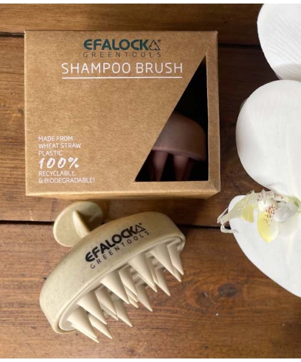 EFALOCK Shampoo Brush Rose på et bord ved siden af en blomst.