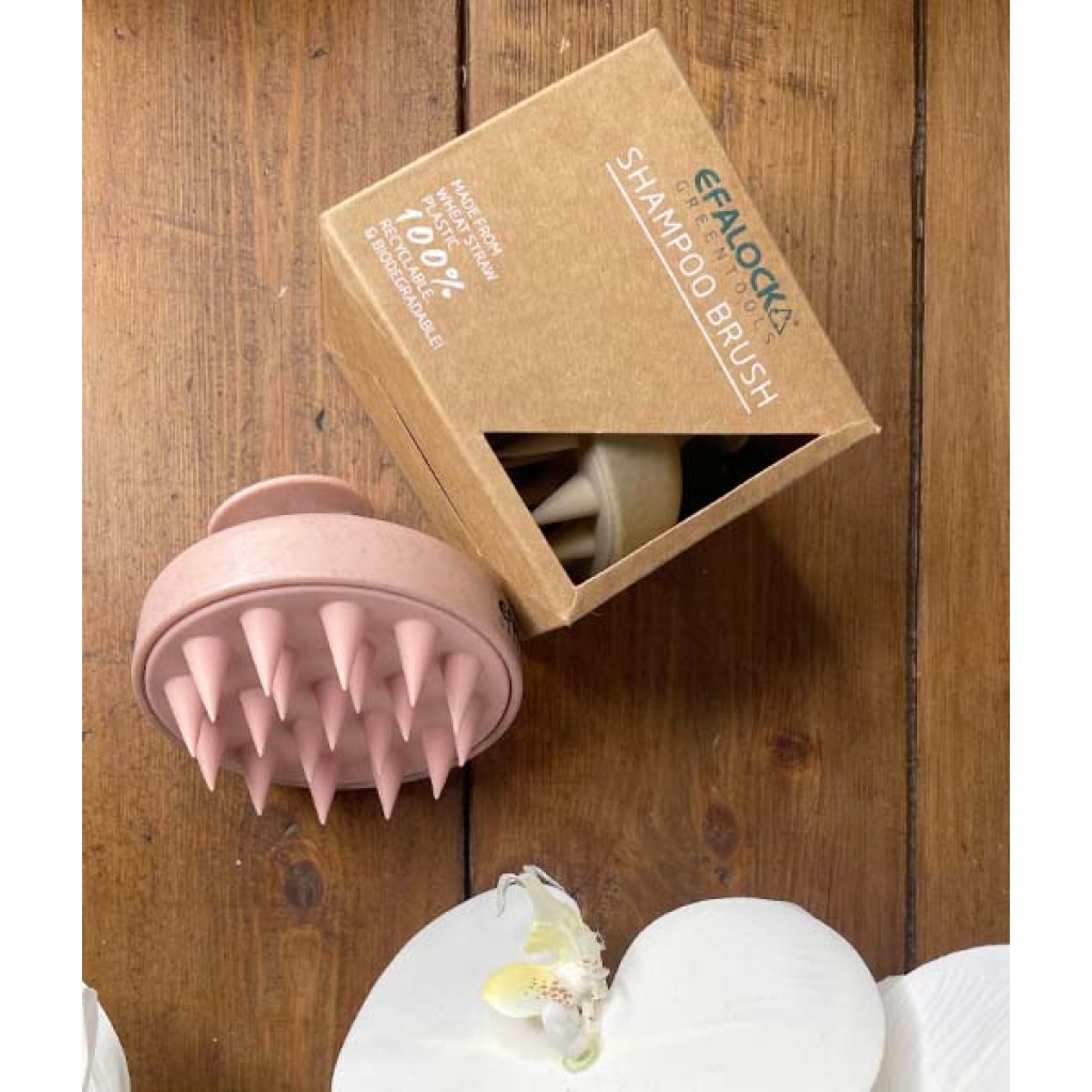 En æske indeholdende en EFALOCK Shampoo Brush Rose - 100% hvedestrå plastik og en æske med blomster.