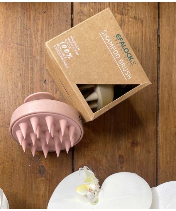 En æske indeholdende en EFALOCK Shampoo Brush Rose - 100% hvedestrå plastik og en æske med blomster.