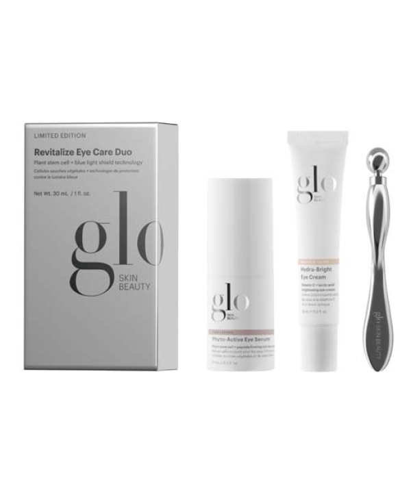 Billede af Glo Skin Beauty Revitalize Eye Care Duo-sættet, der indeholder Phyto-Active Eye Serum, Hydra-Bright Eye Cream og en metalapplikator, vist på en almindelig baggrund.